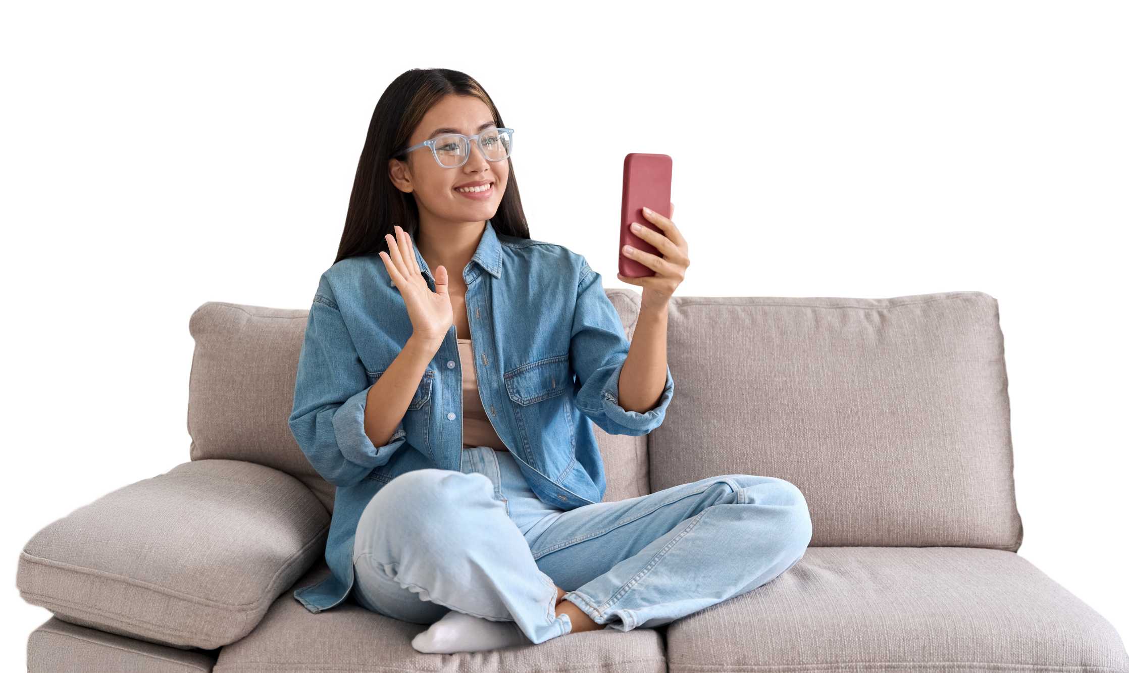 a young woman sitting on a couch talking on a phone