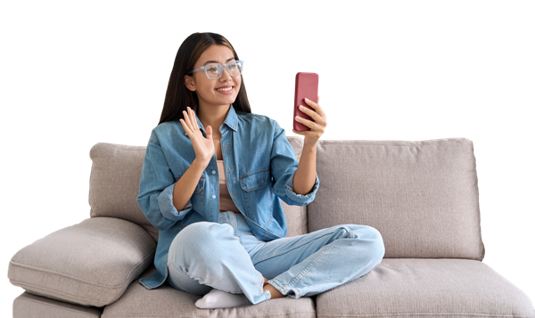 a-young-woman-sitting-on-a-couch-talking-on-a-phone a young woman sitting on a couch talking on a phone